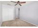This bedroom boasts a ceiling fan and closet for ample storage at 924 E Baylor Ln, Gilbert, AZ 85296