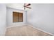 Neutral bedroom with light colored carpet, ceiling fan, and large window for natural light at 924 E Baylor Ln, Gilbert, AZ 85296