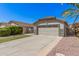 Inviting one-story home with a two-car garage, well-manicured landscaping and concrete driveway at 924 E Baylor Ln, Gilbert, AZ 85296
