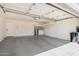 Spacious two-car garage with overhead storage racks and ample room for vehicles at 924 E Baylor Ln, Gilbert, AZ 85296