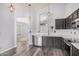 Open kitchen with stainless steel appliances, dark cabinetry and an arched entryway at 924 E Baylor Ln, Gilbert, AZ 85296