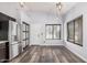 A spacious living room with modern lighting, gray paint, and wood flooring at 924 E Baylor Ln, Gilbert, AZ 85296