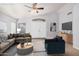 A staged living room with vaulted ceilings, a comfortable sofa, a chair, and lots of natural light at 924 E Baylor Ln, Gilbert, AZ 85296