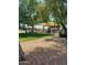 Community playground with shade structures, picnic tables, and play equipment surrounded by mature trees at 924 E Baylor Ln, Gilbert, AZ 85296