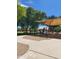 Playground with shade structure, benches, and playground equipment surrounded by green grass and trees at 924 E Baylor Ln, Gilbert, AZ 85296