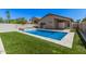 Backyard pool area, features a well-maintained lawn, and a privacy fence at 924 E Baylor Ln, Gilbert, AZ 85296