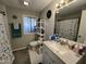 Well-lit bathroom with a large mirror, a single sink vanity, and a window at 9302 E Broadway Rd # 49, Mesa, AZ 85208