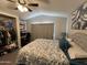 Comfortable bedroom featuring a ceiling fan, a closet and an en-suite desk at 9302 E Broadway Rd # 49, Mesa, AZ 85208
