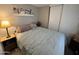 Simple bedroom with a soft blue comforter, side tables, and neutral walls at 9302 E Broadway Rd # 49, Mesa, AZ 85208