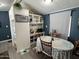 Cozy dining nook features built-in shelving and a charming dining table at 9302 E Broadway Rd # 49, Mesa, AZ 85208