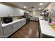 Updated kitchen boasts gray cabinets, stone countertops, and stainless steel appliances at 9302 E Broadway Rd # 49, Mesa, AZ 85208