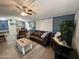 Inviting living room features cozy furniture, a ceiling fan and neutral flooring at 9302 E Broadway Rd # 49, Mesa, AZ 85208
