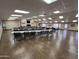 A spacious meeting room featuring tables and chairs, perfect for gatherings at 9302 E Broadway Rd # 49, Mesa, AZ 85208