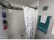 Clean shower with white tiled walls, shower curtain, and a towel rack at 9302 E Broadway Rd # 49, Mesa, AZ 85208