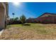 A desert back yard featuring string lights and a small tree at 9438 E Plana Ave, Mesa, AZ 85212