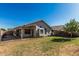 View of a backyard with manicured lawn and a covered patio at 9438 E Plana Ave, Mesa, AZ 85212