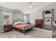Comfortable bedroom with carpet, ceiling fan, two dressers, and natural light at 9438 E Plana Ave, Mesa, AZ 85212