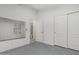 Minimalist bedroom featuring a sliding door closet and an ensuite bathroom at 9438 E Plana Ave, Mesa, AZ 85212