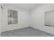 Neutral bedroom featuring a window, a mirror and painted in a monochromatic scheme at 9438 E Plana Ave, Mesa, AZ 85212