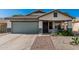 Charming single-story home features a desert landscaped front yard and a two-car garage at 9438 E Plana Ave, Mesa, AZ 85212