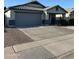 Well-maintained home with a two-car garage and desert-style front yard landscaping at 9438 E Plana Ave, Mesa, AZ 85212