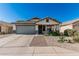 Charming single-story home features a desert landscaped front yard and a two-car garage at 9438 E Plana Ave, Mesa, AZ 85212
