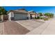 A single-story home features a two-car garage and desert landscaping at 9438 E Plana Ave, Mesa, AZ 85212