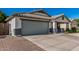 A single-story home features a two-car garage and desert landscaping at 9438 E Plana Ave, Mesa, AZ 85212