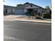 Attractive single-story home with desert landscaping, a two-car garage and covered entry at 9438 E Plana Ave, Mesa, AZ 85212