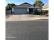 Charming single-Gathering home featuring a two-car garage, desert landscaping, and neutral color palette at 9438 E Plana Ave, Mesa, AZ 85212