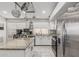 Modern kitchen with granite countertops, a center island, stainless steel appliances, and bright lighting at 9438 E Plana Ave, Mesa, AZ 85212