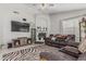 Inviting living room features a zebra rug, fireplace, ceiling fan and a comfortable reclining couch at 9438 E Plana Ave, Mesa, AZ 85212