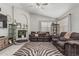 Spacious living room with tile floors, a fireplace, and comfortable seating at 9438 E Plana Ave, Mesa, AZ 85212