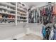 Spacious walk-in closet with ample shelving, hanging racks and carpet flooring at 9438 E Plana Ave, Mesa, AZ 85212