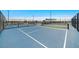 Community tennis courts with fencing, lighting, and well-maintained playing surfaces for tennis enthusiasts at 10211 W Columbus Ave, Avondale, AZ 85392