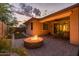 Backyard features a brick patio with fire pit, built-in seating, and manicured landscaping at 10539 E Corbin Ave, Mesa, AZ 85212