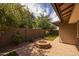 Landscaped backyard featuring a brick fire pit, green lawn, and privacy wall at 10539 E Corbin Ave, Mesa, AZ 85212