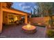 Backyard featuring a stone fire pit, pavers, covered patio, and an outdoor dining area at 10539 E Corbin Ave, Mesa, AZ 85212