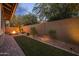 Wide view of the backyard with a brick paver walkway and a stone fire pit at 10539 E Corbin Ave, Mesa, AZ 85212