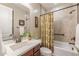 This traditional bathroom has a shower-tub combo with a vanity, a mirror, and neutral colors at 10539 E Corbin Ave, Mesa, AZ 85212