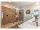 Bathroom featuring a tiled walk-in shower with glass door and a white single sink vanity at 10539 E Corbin Ave, Mesa, AZ 85212