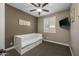 Inviting bedroom showcases a daybed, plantation shutters, and ceiling fan for a cozy, relaxing atmosphere at 10539 E Corbin Ave, Mesa, AZ 85212