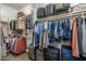 Walk-in closet offers ample storage space with shelving, rods, and designated areas for luggage and accessories at 10539 E Corbin Ave, Mesa, AZ 85212
