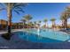 The beautiful pool area is surrounded by lush palm trees and lounge chairs, perfect for relaxation at 10539 E Corbin Ave, Mesa, AZ 85212