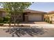 Charming single-story home featuring a two-car garage, brick driveway, and well-manicured landscaping at 10539 E Corbin Ave, Mesa, AZ 85212