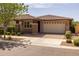 Charming single-story home featuring a two-car garage, brick driveway, and well-manicured landscaping at 10539 E Corbin Ave, Mesa, AZ 85212