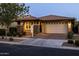Charming single-story home featuring a two-car garage, brick driveway, and well-manicured landscaping at 10539 E Corbin Ave, Mesa, AZ 85212