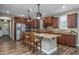 Stylish kitchen with granite island, stainless steel appliances, custom cabinets, and wood-look flooring at 10539 E Corbin Ave, Mesa, AZ 85212