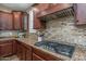 Well-equipped kitchen with gas cooktop, stainless steel appliances, and mosaic backsplash at 10539 E Corbin Ave, Mesa, AZ 85212
