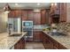 Modern kitchen with stainless steel appliances, granite countertops, mosaic backsplash, and custom cabinetry at 10539 E Corbin Ave, Mesa, AZ 85212